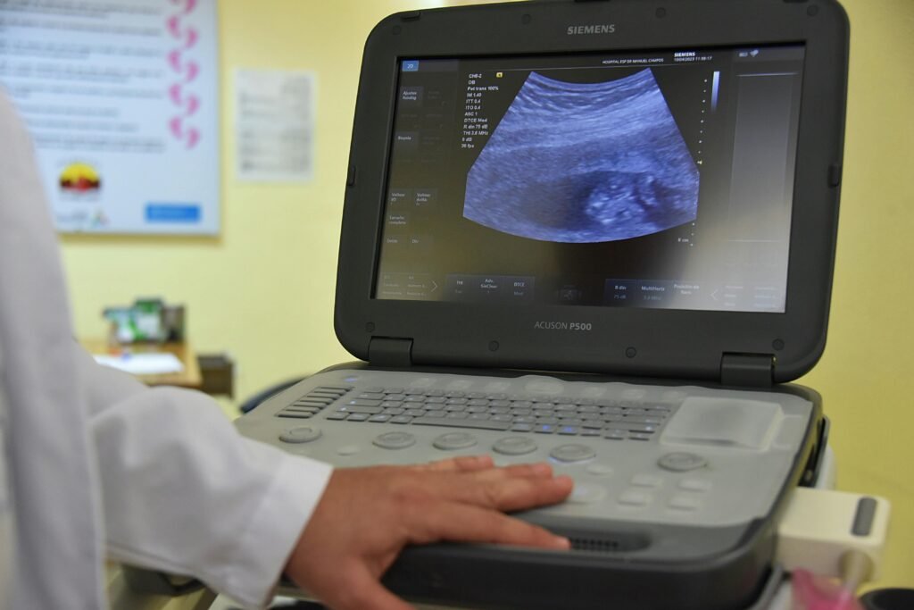 pexels-photo-16388113-16388113 A close-up of a doctor performing an ultrasound scan, focusing on medical technology in practice.